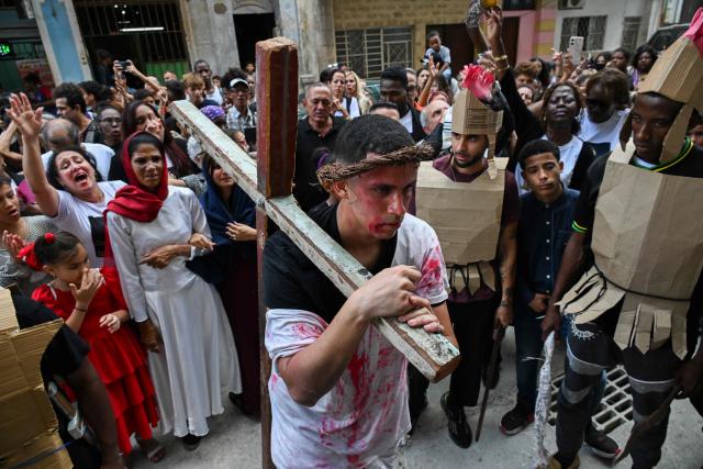 Youngsters enact the Passion of Jesus Christ during a procession marking the Way of the Cross on Good Friday in Havana on April 3, 2026. (Photo by YAMIL LAGE / AFP)