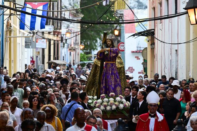 Catholic faithful take part in the Via Crucis (Way of the Cross) on Good Friday during Holy Week in Havana on April 3, 2026. (Photo by YAMIL LAGE / AFP)
