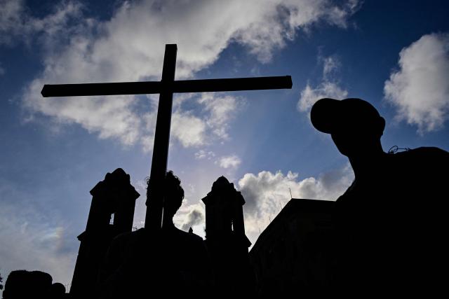 Catholic faithful take part in the Via Crucis (Way of the Cross) on Good Friday during Holy Week in Havana on April 3, 2026. (Photo by YAMIL LAGE / AFP)
