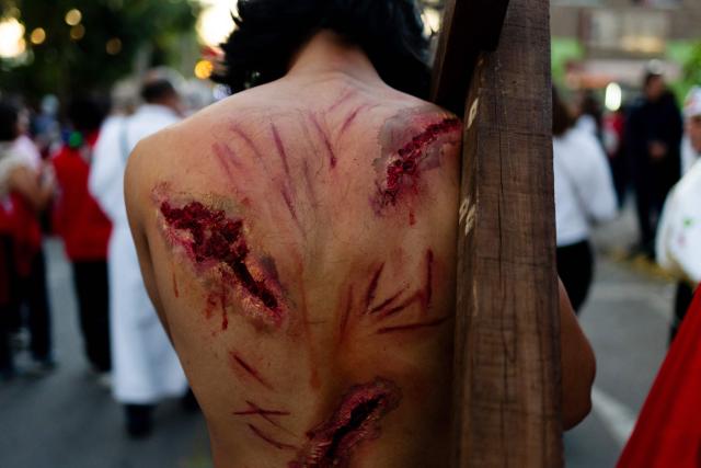 A youngster from the Sacred Heart of Jesus Parish enacts the Passion of Jesus Christ during Via Crusis (Way of the Cross) on Good Friday in Colina, Chile on April 3, 2026. (Photo by Javier TORRES / AFP)