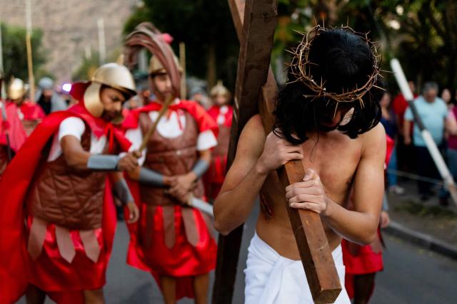 Youngsters from the Sacred Heart of Jesus Parish enact the Passion of Jesus Christ during Via Crusis (Way of the Cross) on Good Friday in Colina, Chile on April 3, 2026. (Photo by Javier TORRES / AFP)