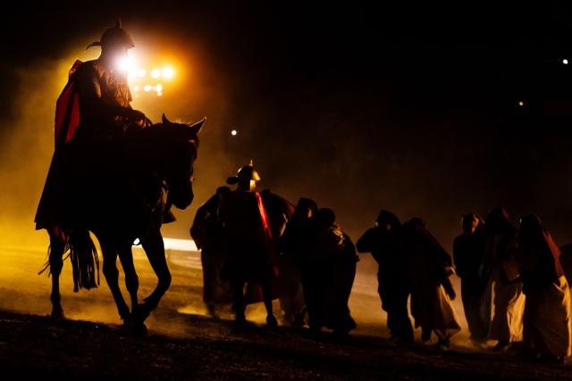 Youngsters from the Sacred Heart of Jesus Parish enact the Passion of Jesus Christ during Via Crusis (Way of the Cross) on Good Friday in Colina, Chile on April 3, 2026. (Photo by Javier TORRES / AFP)