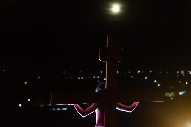Youngsters from the Sacred Heart of Jesus Parish enact the Passion of Jesus Christ during Via Crusis (Way of the Cross) on Good Friday in Colina, Chile on April 3, 2026. (Photo by Javier TORRES / AFP)
