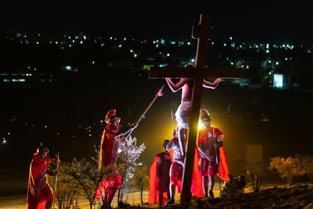 TOPSHOT - Youngsters from the Sacred Heart of Jesus Parish enact the Passion of Jesus Christ during Via Crusis (Way of the Cross) on Good Friday in Colina, Chile on April 3, 2026. (Photo by Javier TORRES / AFP)