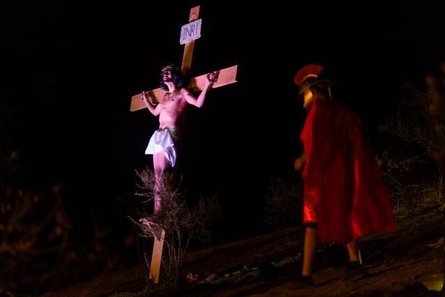 Youngsters from the Sacred Heart of Jesus Parish enact the Passion of Jesus Christ during Via Crusis (Way of the Cross) on Good Friday in Colina, Chile on April 3, 2026. (Photo by Javier TORRES / AFP)