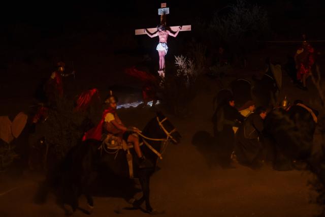 Youngsters from the Sacred Heart of Jesus Parish enact the Passion of Jesus Christ during Via Crusis (Way of the Cross) on Good Friday in Colina, Chile on April 3, 2026. (Photo by Javier TORRES / AFP)