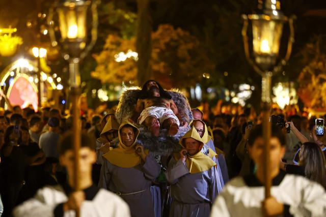 Catholic faithful take part in the traditional Stations of the Cross procession, reenacting the final hours of Jesus Christ’s life, lighting up the streets with torches and candles in Gramado, Rio Grande do Sul state, Brazil on April 3, 2026. (Photo by SILVIO AVILA / AFP)