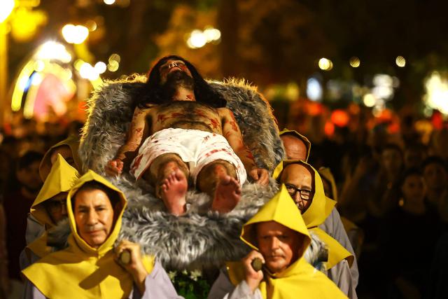 Catholic faithful take part in the traditional Stations of the Cross procession, reenacting the final hours of Jesus Christ’s life, lighting up the streets with torches and candles in Gramado, Rio Grande do Sul state, Brazil on April 3, 2026. (Photo by SILVIO AVILA / AFP)
