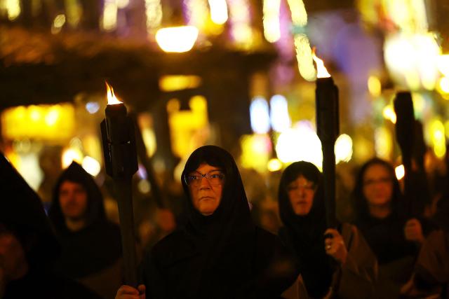 Catholic faithful take part in the traditional Stations of the Cross procession, reenacting the final hours of Jesus Christ’s life, lighting up the streets with torches and candles in Gramado, Rio Grande do Sul state, Brazil on April 3, 2026. (Photo by SILVIO AVILA / AFP)