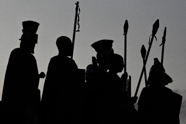 Catholic faithful enact the Passion of Jesus Christ as they take part in Via Crucis (Way of the Cross) on Good Friday at the Petare neighborhood in Caracas on April 3, 2026. (Photo by Maryorin Mendez / AFP)