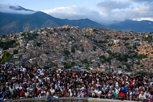 TOPSHOT - Catholic faithful watch a representation of the Passion of Jesus Christ during Via Crucis (Way of the Cross) on Good Friday in the Petare neighborhood in Caracas on April 3, 2026. (Photo by Maryorin Mendez / AFP)