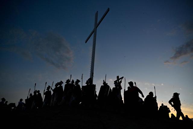Catholic faithful enact the Passion of Jesus Christ as they take part in Via Crucis (Way of the Cross) on Good Friday at the Petare neighborhood in Caracas on April 3, 2026. (Photo by Maryorin Mendez / AFP)