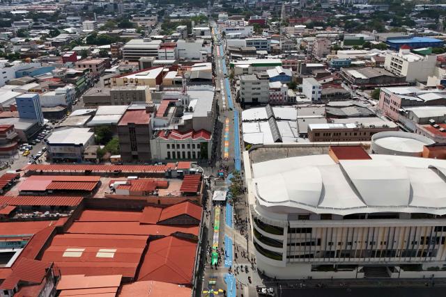 This aerial view shows a salt carpet of over one kilometer, considered the largest in Central America, during Holy Week celebrations in the historic center of San Salvador on April 3, 2026. (Photo by Marvin RECINOS / AFP)
