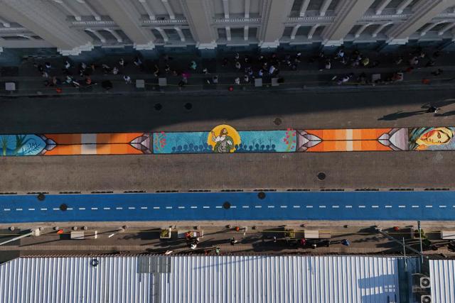This aerial view shows a salt carpet of over one kilometer, considered the largest in Central America, during Holy Week celebrations in the historic center of San Salvador on April 3, 2026. (Photo by Marvin RECINOS / AFP)