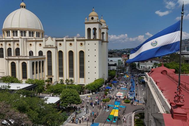 TOPSHOT - This aerial view shows a salt carpet of over one kilometer, considered the largest in Central America, during Holy Week celebrations in the historic center of San Salvador on April 3, 2026. (Photo by Marvin RECINOS / AFP)