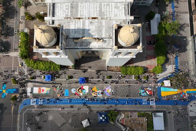 This aerial view shows a salt carpet of over one kilometer, considered the largest in Central America, during Holy Week celebrations in the historic center of San Salvador on April 3, 2026. (Photo by Marvin RECINOS / AFP)