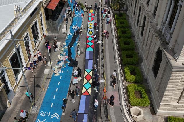 This aerial view shows a salt carpet of over one kilometer, considered the largest in Central America, during Holy Week celebrations in the historic center of San Salvador on April 3, 2026. (Photo by Marvin RECINOS / AFP)