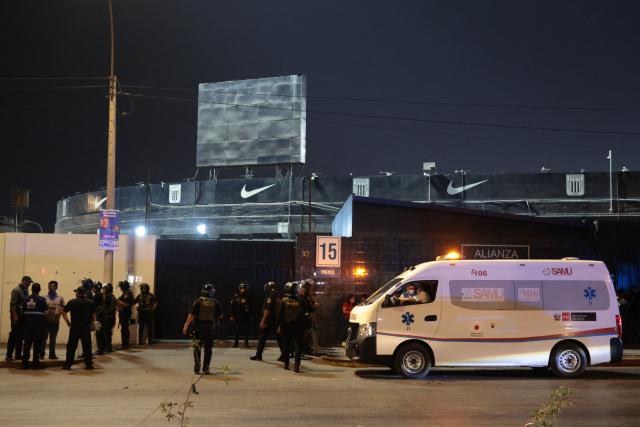 An ambulance is seen at the entrance of the Alejandro Villanueva Stadium after an accident in the stands where Alianza Lima's fans were cheering for their team on the eve of the match against Universitario in Lima on April 3, 2026. At least one person was killed and 47 others were injured, including three minors, in “an incident” that occurred Friday at Alianza Lima's stadium in Peru during a flag-waving rally in support of the team ahead of the Peruvian football derby, the Ministry of Health reported. (Photo by Connie FRANCE / AFP)