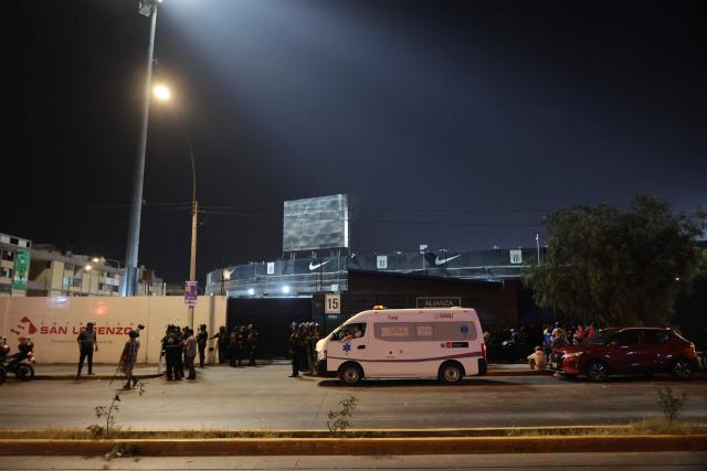 An ambulance is seen at the entrance of the Alejandro Villanueva Stadium after an accident in the stands where Alianza Lima's fans were cheering for their team on the eve of the match against Universitario in Lima on April 3, 2026. At least one person was killed and 47 others were injured, including three minors, in “an incident” that occurred Friday at Alianza Lima's stadium in Peru during a flag-waving rally in support of the team ahead of the Peruvian football derby, the Ministry of Health reported. (Photo by Connie FRANCE / AFP)