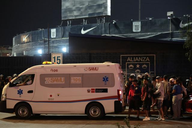 Relatives wait for news at the entrance of the Alejandro Villanueva Stadium after an accident in the stands where Alianza Lima's fans were cheering for their team on the eve of the match against Universitario in Lima on April 3, 2026. At least one person was killed and 47 others were injured, including three minors, in “an incident” that occurred Friday at Alianza Lima's stadium in Peru during a flag-waving rally in support of the team ahead of the Peruvian football derby, the Ministry of Health reported. (Photo by Connie FRANCE / AFP)