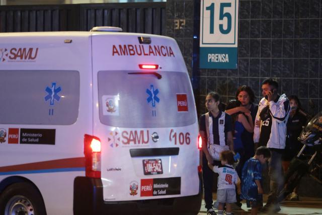 Relatives wait for news at the entrance of the Alejandro Villanueva Stadium after an accident in the stands where Alianza Lima's fans were cheering for their team on the eve of the match against Universitario in Lima on April 3, 2026. At least one person was killed and 47 others were injured, including three minors, in “an incident” that occurred Friday at Alianza Lima's stadium in Peru during a flag-waving rally in support of the team ahead of the Peruvian football derby, the Ministry of Health reported. (Photo by Connie FRANCE / AFP)
