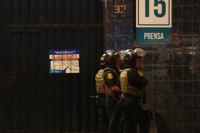 A "Closure" poster is seen at the entrance of the Alejandro Villanueva Stadium while police officers stand guard after an accident in the stands where Alianza Lima's fans were cheering for their team on the eve of the match against Universitario in Lima on April 3, 2026. At least one person was killed and 47 others were injured, including three minors, in “an incident” that occurred Friday at Alianza Lima's stadium in Peru during a flag-waving rally in support of the team ahead of the Peruvian football derby, the Ministry of Health reported. (Photo by Connie FRANCE / AFP)