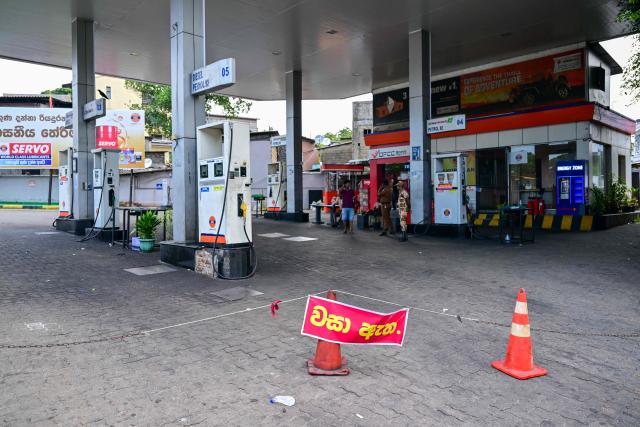 A sign reading 'Closed' is displayed at a Lanka IOC fuel station in Kotahena on the outskirts of Colombo on March 17, 2026. Sri Lanka is struggling to prevent a repeat of its spectacular economic collapse four years ago, as the prolonged Middle East war compounds the fallout from a deadly cyclone in November. (Photo by Ishara S. KODIKARA / AFP)