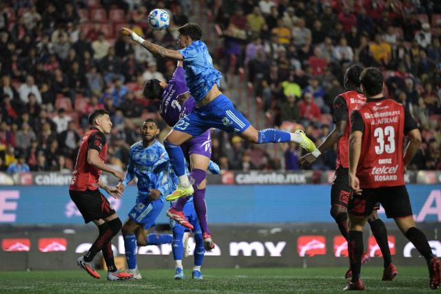 Tijuana's goalkeeper #02 Antonio Rodriguez an Tigres' Brazilian midfielder #23 Romulo Zwarg fight for the ball during the Liga MX Clausura football match between Tijuana and Tigres at Caliente stadium in Tijuana, Mexico on April 3, 2026. (Photo by Guillermo Arias / AFP)