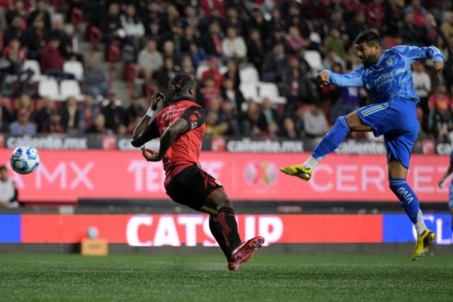 Tigres’ Uruguayan forward #17 Rodrigo Aguirre shoots the ball next to Tijuana's Ecuadorian defender #12 Jackson Porozo during the Liga MX Clausura football match between Tijuana and Tigres at Caliente stadium in Tijuana, Mexico on April 3, 2026. (Photo by Guillermo Arias / AFP)