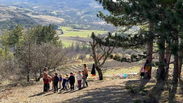 Kindergarten pupils attend a class outside in Sederon, southern France, on March 13, 2026. Just like every Friday morning, the fourteen children in the combined kindergarten-first-grade class at the public school in Sйderon make their way up a hill overlooking the village. They’re heading out for outdoor learning. (Photo by Guillaume BONNET / AFP)