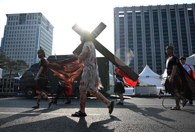 Participants in costumes take part in an Easter parade at Gwanghwamun Square in Seoul on April 4, 2026. (Photo by Jung Yeon-je / AFP)