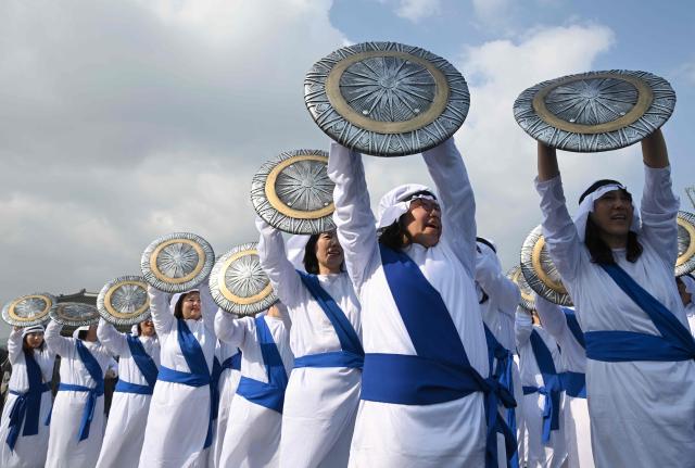 Participants in costumes take part in an Easter parade at Gwanghwamun Square in Seoul on April 4, 2026. (Photo by Jung Yeon-je / AFP)
