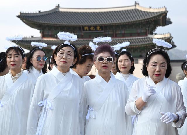 Participants in costumes take part in an Easter parade at Gwanghwamun Square in Seoul on April 4, 2026. (Photo by Jung Yeon-je / AFP)