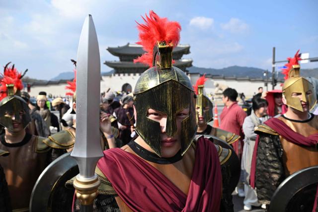 Participants in costumes take part in an Easter parade at Gwanghwamun Square in Seoul on April 4, 2026. (Photo by Jung Yeon-je / AFP)