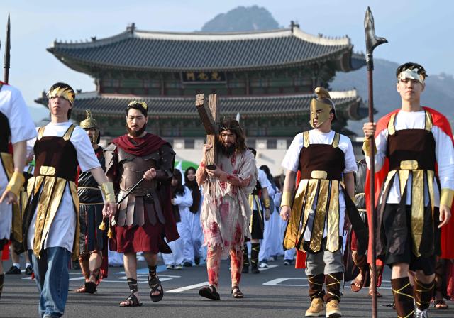 Participants in costumes take part in an Easter parade at Gwanghwamun Square in Seoul on April 4, 2026. (Photo by Jung Yeon-je / AFP)