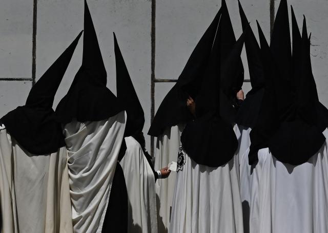 Penitents of the ‘El Cachorro’ brotherhood prepare to take part in Good Friday procession during Holy Week in Seville, on April 3, 2026. Christian believers around the world mark the Holy Week of Easter in celebration of the crucifixion and resurrection of Jesus Christ. (Photo by CRISTINA QUICLER / AFP)