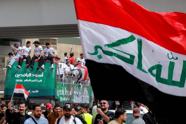Members of Iraq's men's national football team sit atop a double-decker bus as they are paraded with fans in the Jadriya area of central Baghdad on April 4, 2026 to celebrate the country's qualification to the 2026 FIFA World Cup to be held in North America in the summer. The "Lions of Mesopotamia" secured the country's first World Cup appearance since the 1986 competition in Mexico with a 2-1 win over Bolivia late on March 31. The build-up to the match had been overshadowed by the outbreak of the Middle East war in late February, when the US and Israel attacked Iran, subsequently dragging Iraq into the conflict. (Photo by MURTAJA LATEEF / AFP)
