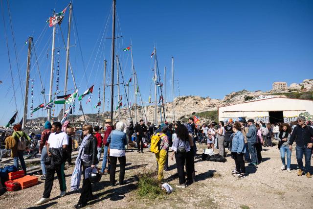 Activists gather in l'Estaque, part of Marseille's harbour, southern France, on April 4, 2026, during a rally in support of a flotilla carrying activists from “Thousand Madleens to Gaza” movement as they prepare to set sail. (Photo by CLEMENT MAHOUDEAU / AFP)