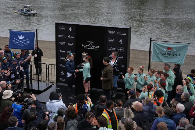 Oxford President Heidi Long (L) and Cambridge President Gemma King (R) shake hands at the coin toss ahead of the 80th Women's boat race between Oxford University and Cambridge University on the River Thames in London on April 4, 2026. (Photo by CARLOS JASSO / AFP)