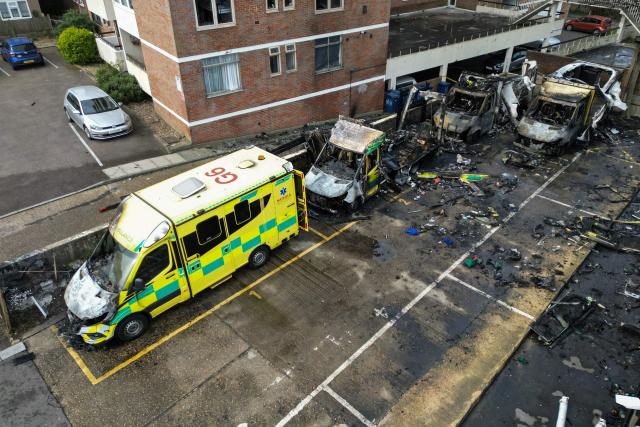 (FILES) This aerial image shows burnt out ambulances in a parking area along a street in the Golders Green neighbourhood of north London on March 23, 2026, after the volunteer ambulances run by a Jewish organisation were set on fire overnight. Three young men have been charged with arson over the vandalizing of four ambulances run by a Jewish charity in London, British police said Friday, April 3. (Photo by Henry NICHOLLS / AFP)