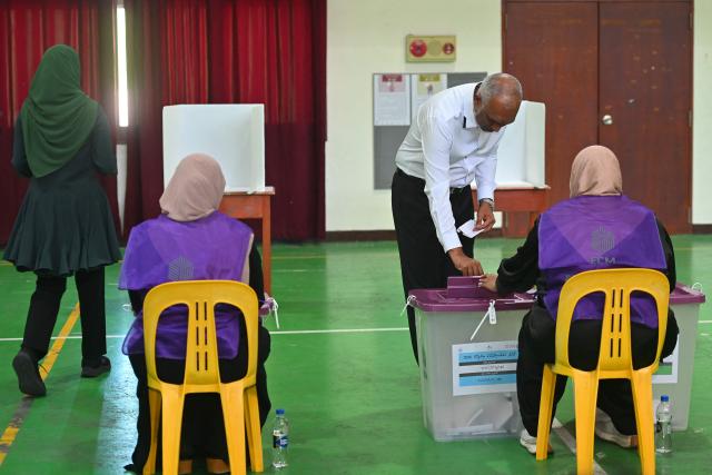 Maldives' President Mohamed Muizzu casts his ballot at a polling station in Malé on April 4, 2026 as voting opens for the local council elections as well as a referendum on holding Presidential and Parliamentary elections on the same day.  (Photo by Mohamed Afrah / AFP)