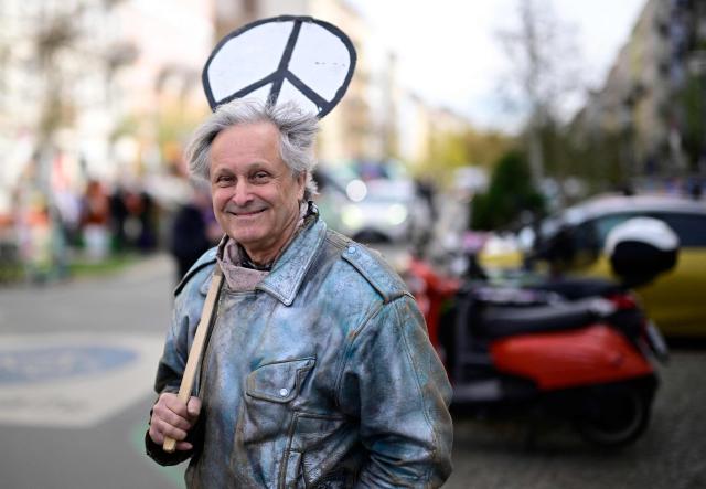 A protester holds a peace sign during an Easter March Peace demonstration organised by the Berlin Peace Coordination (FRIKO) in Berlin, on April 4, 2026. (Photo by Tobias SCHWARZ / AFP)
