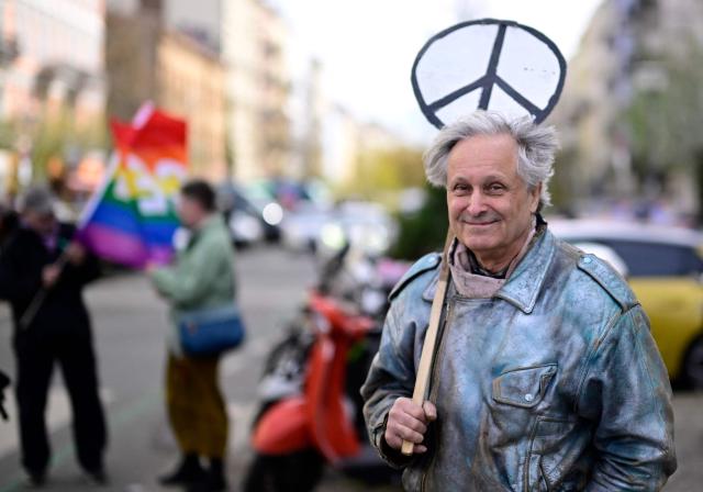 A protester holds a peace sign during an Easter March Peace demonstration organised by the Berlin Peace Coordination (FRIKO) in Berlin, on April 4, 2026. (Photo by Tobias SCHWARZ / AFP)