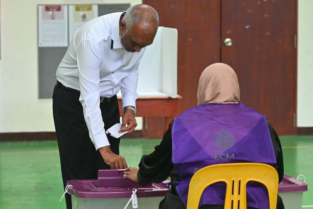 Maldives' President Mohamed Muizzu casts his ballot at a polling station in Malé on April 4, 2026 as voting opens for the local council elections as well as a referendum on holding Presidential and Parliamentary elections on the same day.  (Photo by Mohamed Afrah / AFP)