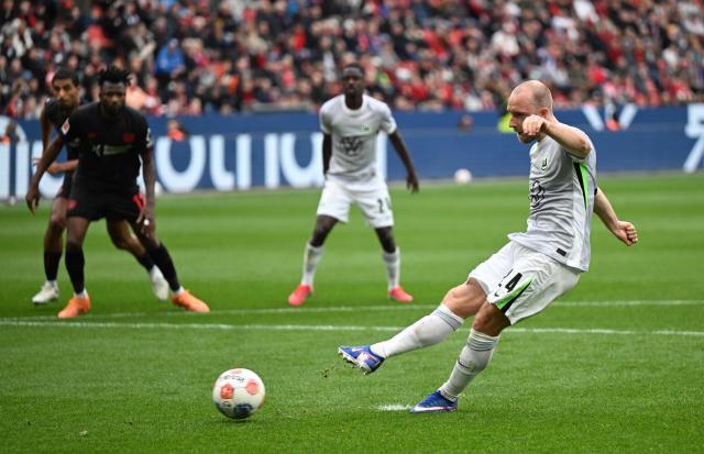 Wolfsburg's Danish midfielder #24 Christian Eriksen scores a penalty during the German first division Bundesliga football match between Bayer leverkusen and VfL Wolfsburg in Leverkusen on April 4, 2026. (Photo by INA FASSBENDER / AFP) / DFL REGULATIONS PROHIBIT ANY USE OF PHOTOGRAPHS AS IMAGE SEQUENCES AND/OR QUASI-VIDEO