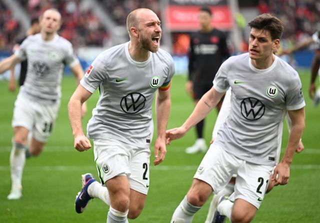 Wolfsburg's Danish midfielder #24 Christian Eriksen (C) celebrates scoring a penalty during the German first division Bundesliga football match between Bayer leverkusen and VfL Wolfsburg in Leverkusen on April 4, 2026. (Photo by INA FASSBENDER / AFP) / DFL REGULATIONS PROHIBIT ANY USE OF PHOTOGRAPHS AS IMAGE SEQUENCES AND/OR QUASI-VIDEO