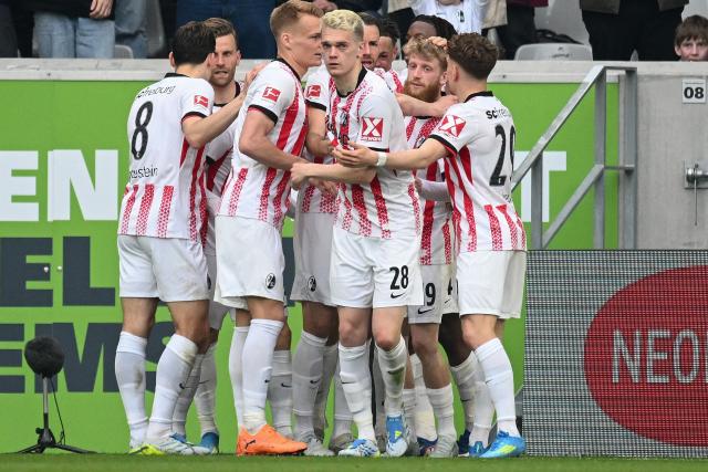 Freiburg's Swiss midfielder #44 Johan Manzambi (hidden) celebrates scoring the opening goal with his teammates during the German first division Bundesliga football match between SC Freiburg and FC Bayern Munich in Freiburg, southern Germany on April 4, 2026. (Photo by Silas STEIN / AFP) / DFL REGULATIONS PROHIBIT ANY USE OF PHOTOGRAPHS AS IMAGE SEQUENCES AND/OR QUASI-VIDEO