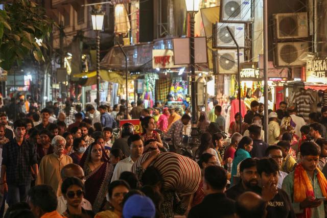 People throng a market in Varanasi on April 4, 2026. (Photo by Niharika KULKARNI / AFP)