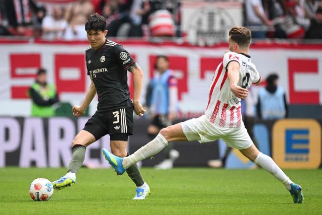 Bayern Munich's South Korean defender #03 Kim Min-Jae and Freiburg's German forward #09 Lucas Hoeler vie for the ball during the German first division Bundesliga football match between SC Freiburg and FC Bayern Munich in Freiburg, southern Germany on April 4, 2026. (Photo by Silas STEIN / AFP) / DFL REGULATIONS PROHIBIT ANY USE OF PHOTOGRAPHS AS IMAGE SEQUENCES AND/OR QUASI-VIDEO