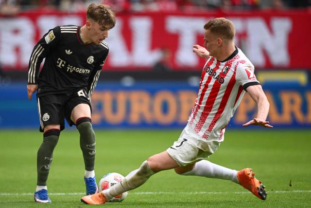 Bayern Munich's German midfielder #42 Lennart Karl (L) and Freiburg's Austrian defender #03 Philipp Lienhart vie for the ball during the German first division Bundesliga football match between SC Freiburg and FC Bayern Munich in Freiburg, southern Germany on April 4, 2026. (Photo by Silas STEIN / AFP) / DFL REGULATIONS PROHIBIT ANY USE OF PHOTOGRAPHS AS IMAGE SEQUENCES AND/OR QUASI-VIDEO